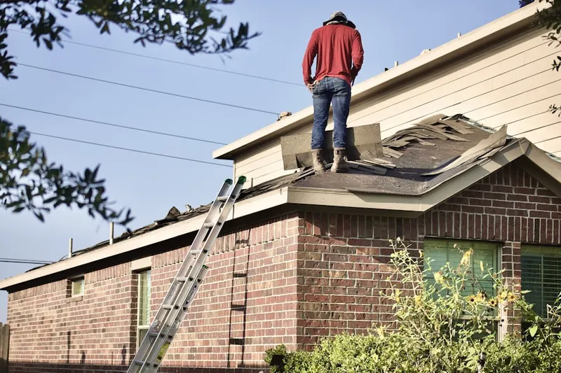 Professional roofer working on a residential roof in Deerfield